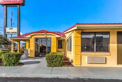 a yellow building on the side of a street at Econo Lodge in Norwalk