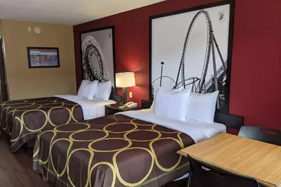 a hotel room with two beds and a large window at Super 8 by Wyndham Sandusky in Sandusky
