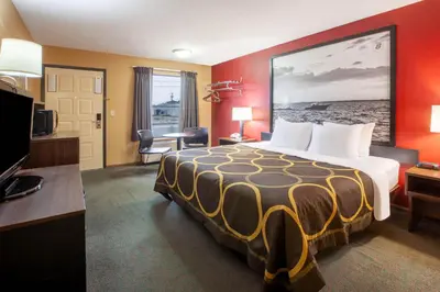 a hotel room with a bed and a television at Super 8 by Wyndham Sandusky in Sandusky