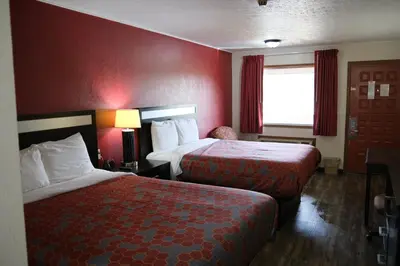 a hotel room with two beds and a window at Econo Lodge Wooster in Wooster