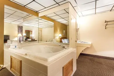a large bathroom with a large tub and a sink at Rodeway Inn Sandusky North in Sandusky