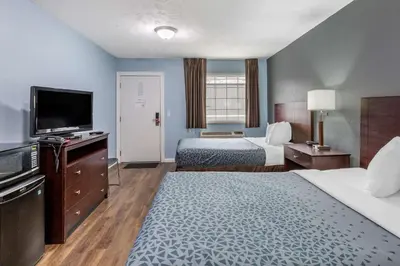 a hotel room with two beds and a flat screen tv at Econo Lodge Inn & Suites Sandusky South in Sandusky