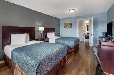 a hotel room with two beds and a television at Econo Lodge Inn & Suites Sandusky South in Sandusky