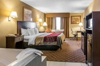 a hotel room with a bed and a bath tub at Quality Inn Defiance in Defiance