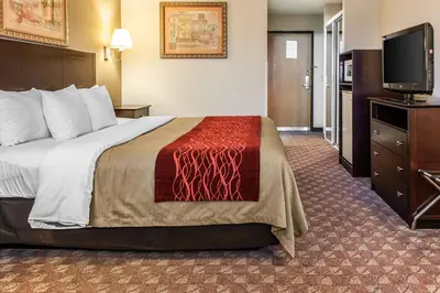 a hotel room with a bed and a flat screen tv at Quality Inn Defiance in Defiance