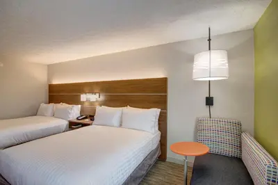 a hotel room with two beds and a table at Holiday Inn Express Columbus South - Obetz by IHG in Obetz