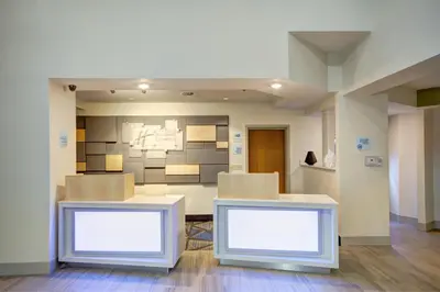 a room with two white tables in a room at Holiday Inn Express Columbus South - Obetz by IHG in Obetz