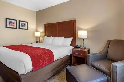a hotel room with a bed and a chair at Comfort Suites Columbus West - Hilliard in Columbus