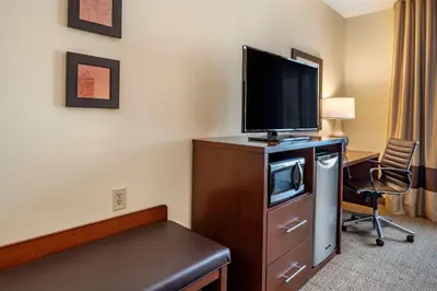 a hotel room with a flat screen tv on a dresser at Comfort Suites Columbus West - Hilliard in Columbus