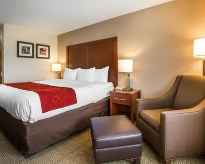 a hotel room with a bed and a chair at Comfort Suites Columbus West - Hilliard in Columbus