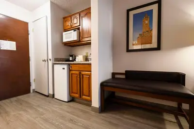 a small kitchen with a bench in a room at Comfort Suites Springfield I-70 in Springfield