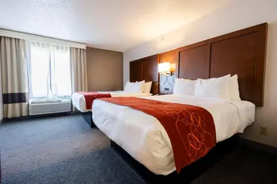 a hotel room with two beds and a window at Comfort Suites Springfield I-70 in Springfield