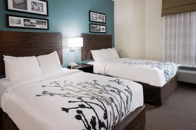 a hotel room with two beds in a room at Sleep Inn & Suites Port Clinton in Port Clinton