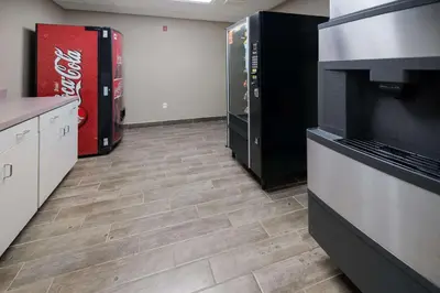 a room with a kitchen with wood floors and appliances at Sleep Inn & Suites Port Clinton in Port Clinton