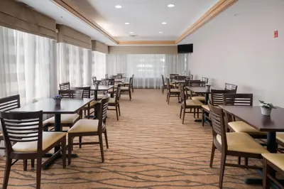 a dining room filled with tables and chairs at Sleep Inn & Suites Port Clinton in Port Clinton