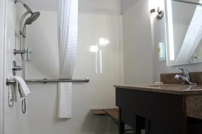a bathroom with a shower and a sink at Comfort Suites Miamisburg - Dayton South in Miamisburg