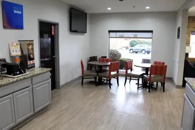 a kitchen and dining room with a table and chairs at Comfort Suites Miamisburg - Dayton South in Miamisburg