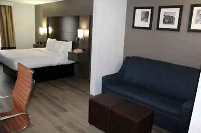 a hotel room with a bed and a couch at Comfort Suites Miamisburg - Dayton South in Miamisburg
