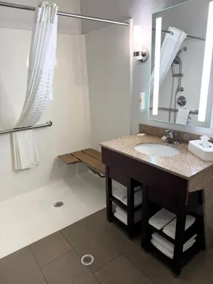 a bathroom with a sink and a mirror at Comfort Suites Miamisburg - Dayton South in Miamisburg