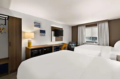 a hotel room with two beds and a television at Comfort Inn & Suites Fremont in Fremont