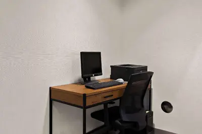 a desk with a computer and a monitor and keyboard at Comfort Inn & Suites Fremont in Fremont