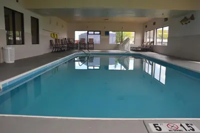 a swimming pool with blue water in a building at Comfort Inn & Suites Maumee - Toledo I80-90 in Maumee