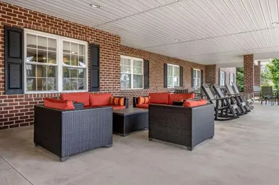 a patio with couches and chairs on a brick wall at Comfort Suites Hotel and Conference Center in Berlin