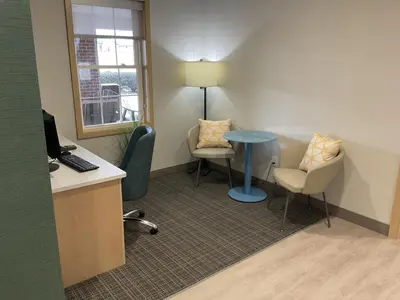 an office with a desk and chairs and a table at Comfort Suites Hotel and Conference Center in Berlin