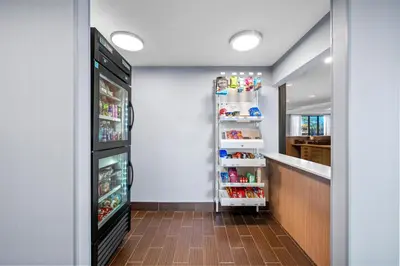 a kitchen with a refrigerator filled with lots of condiments at Spark By Hilton Cleveland Beachwood in Beachwood