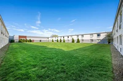 an empty lawn in front of a building at Spark By Hilton Cleveland Beachwood in Beachwood