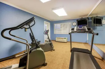 a room with a gym with a treadmill and a computer at Days Inn by Wyndham Austintown in Austintown