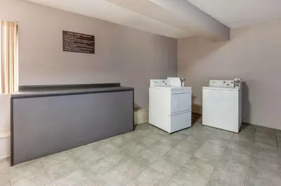 a laundry room with two machines and a counter at Days Inn by Wyndham Austintown in Austintown