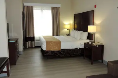 a hotel room with a large bed and a window at Comfort Suites Twinsburg in Twinsburg