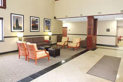 a lobby with a waiting room with a couch and chairs at Comfort Suites Twinsburg in Twinsburg