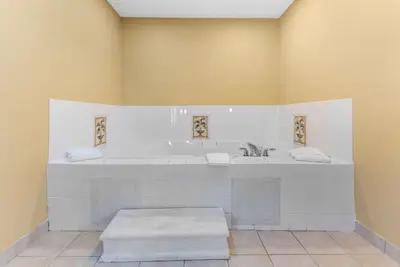 a bathroom with a tub and a sink at Comfort Suites Findlay I-75 near Sports Complex in Findlay