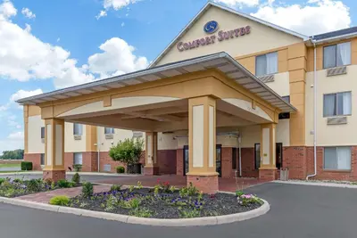 a hotel with a sign on the front of a building at Comfort Suites Findlay I-75 near Sports Complex in Findlay