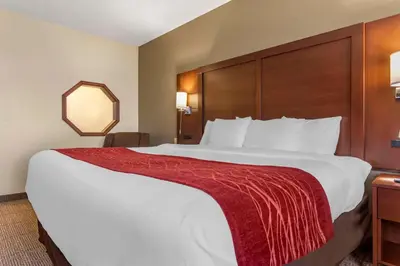a large bed in a hotel room with a red blanket on it at Comfort Inn & Suites Streetsboro - Kent in Streetsboro