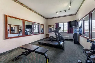 a room with a gym with a treadmill and a television at Comfort Inn & Suites Streetsboro - Kent in Streetsboro