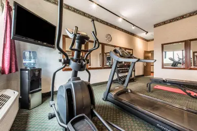 a room with a gym with a treadmill and a flat screen tv at Comfort Inn & Suites Streetsboro - Kent in Streetsboro