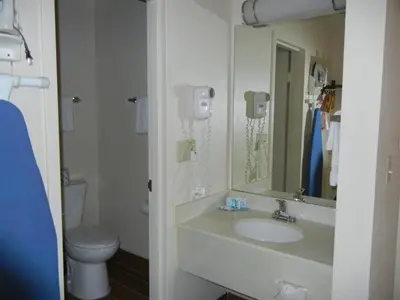 a bathroom with a sink and a toilet and a mirror at Quality Inn Holland - Toledo in Holland