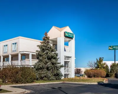 a building with a christmas tree in front of it at Quality Inn Holland - Toledo in Holland