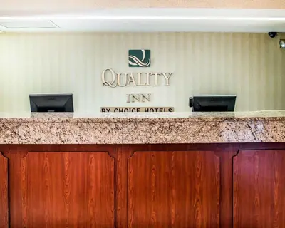 a sign on a wall that reads quality inn at Quality Inn Holland - Toledo in Holland