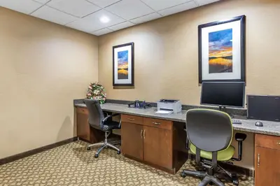 an office with a desk with two chairs and a computer at Comfort Suites South Point - Huntington in Burlington