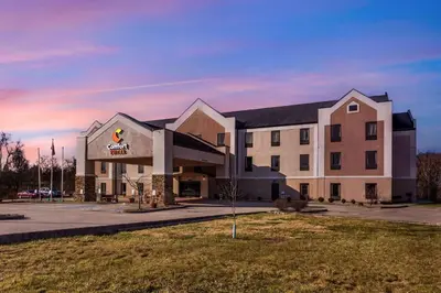 a building with a sign on the front of it at Comfort Suites South Point - Huntington in Burlington