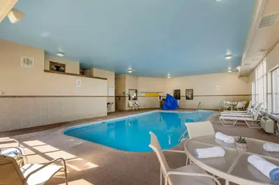 a large pool with chairs and a table in a room at Quality Inn & Suites Delaware South in Delaware