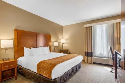 a hotel room with a bed and a television at Comfort Inn North-Polaris in Columbus