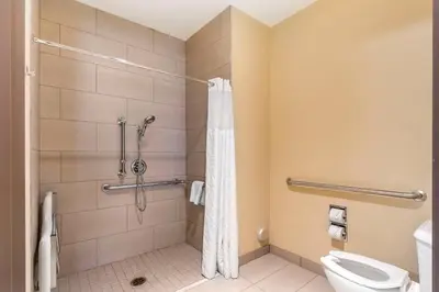 a bathroom with a shower and a toilet at Comfort Inn North-Polaris in Columbus