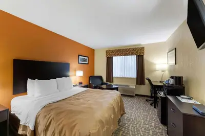 a hotel room with a bed and a desk at Quality Inn Wooster in Wooster