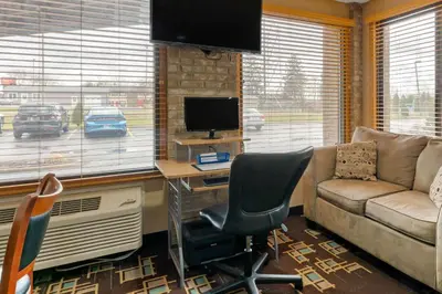 a living room with a couch and a desk with a computer at Quality Inn Wooster in Wooster