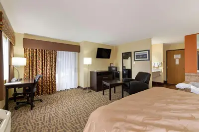 a hotel room with a bed and a desk at Quality Inn Wooster in Wooster